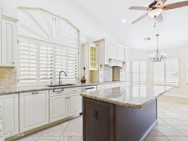 This updated kitchen has plenty of cabinets, beautiful counters & lots of space.