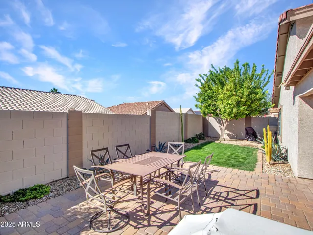 Open paver patio with outdoor dining setup, ideal for entertaining, barbecues, and enjoying Buckeye’s sunny weather.