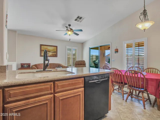 Open kitchen layout overlooking the family and dining spaces, offering a seamless flow ideal for entertaining and modern Buckeye living.