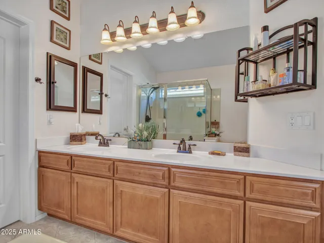 Bright primary bathroom featuring dual sinks, ample storage, and a clean layout designed for daily convenience and comfort.