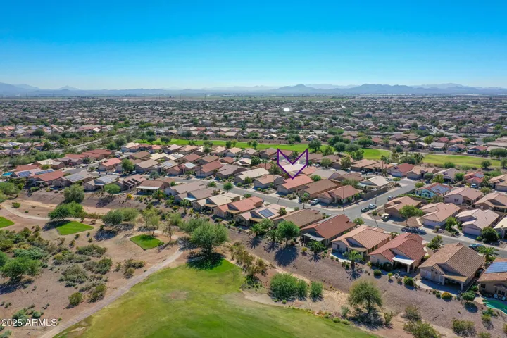 Wide aerial perspective captures the broader Buckeye area, open desert scenery, and residential layout near recreation areas.