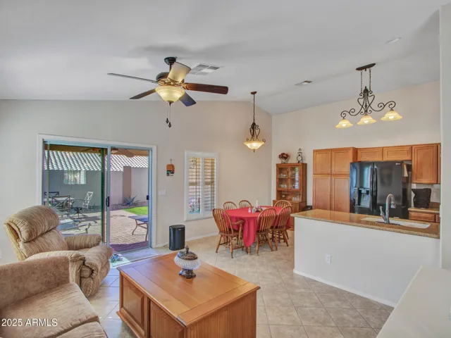 Expansive family room showcasing clear sightlines to the kitchen and dining space. Ideal for gatherings, everyday living, and entertaining in Buckeye.