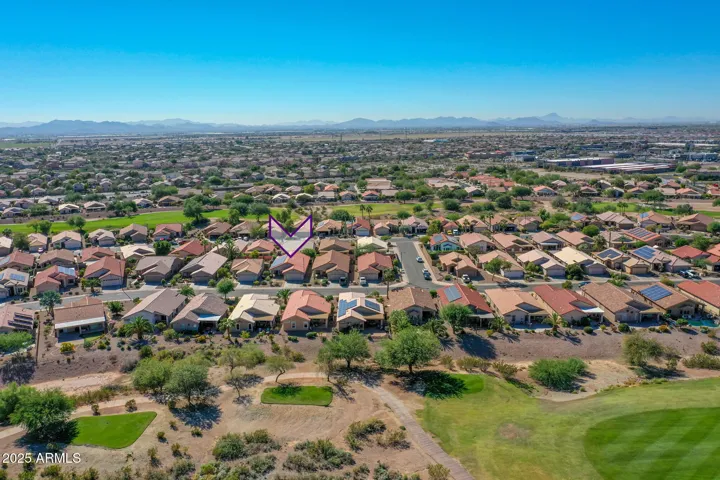 Elevated aerial image showcases the surrounding Buckeye community, nearby open space, and well-maintained homes.