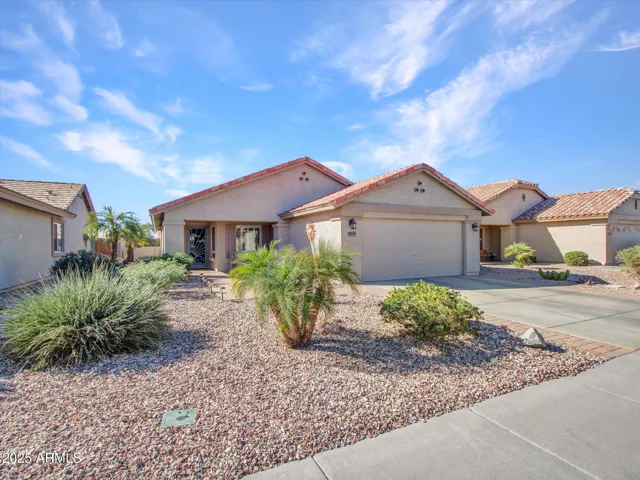 Inviting Buckeye home showcasing desert landscaping, a clean stucco exterior, and low-maintenance design. A welcoming first impression with strong curb appeal and energy-efficient features. Well-maintained stucco exterior with desert plants and paver accents. This Buckeye home offers low upkeep and timeless Southwest style.