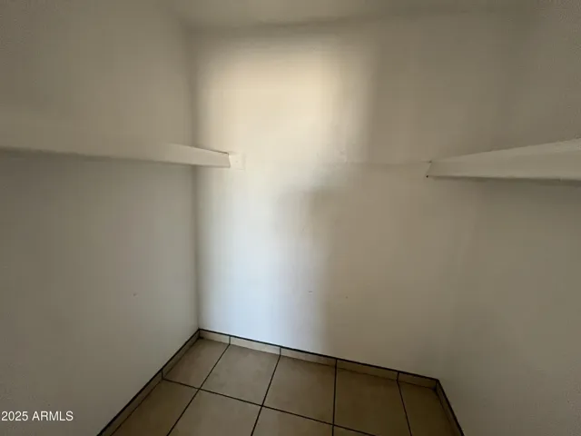 Primary bedroom walk-in closet