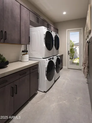 Oversized laundry room w/ 2 sets of w/d, extra cabinets, sink and french door to the backyard