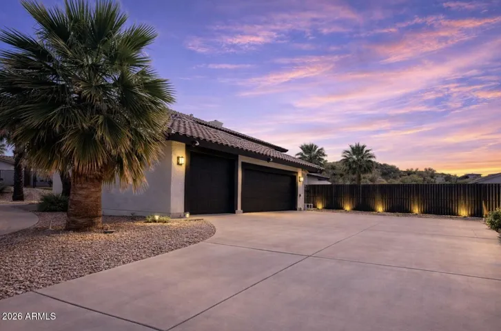 Oversized (Tall) Garage Door & XL Wide driveway situated on the side of the home, with RV gate, parking and plenty of room for full sport court or parking for several cars