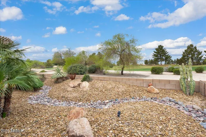 The backyard has low maintenance plants and trees... leaving you to enjoy the views!