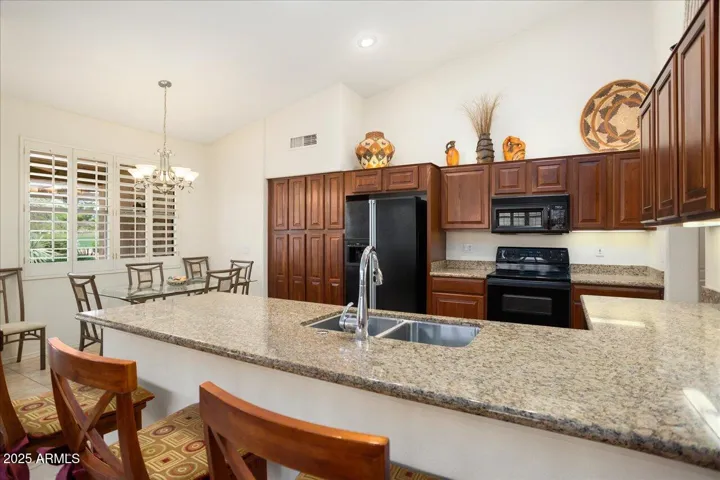 The kitchen offers lots of counter space! The rich granite counters blend smoothly with the warm cherry cabinets!