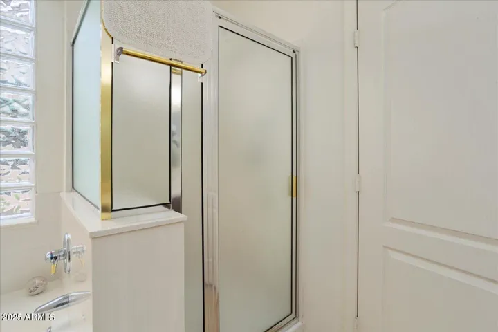 The good sized shower in bath 2 is glass enclosed.
