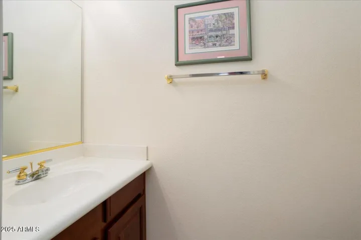The half bath/power room is just off the family room, kitchen and laundry room... and conveniently close when entertaining on the patio!