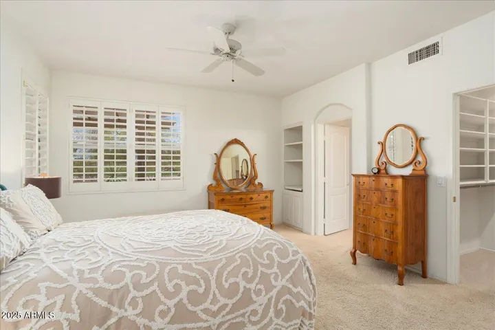 The home has a unique floorplan with TWO primary bedrooms. This is the bedroom at the back of the house with golf course views.