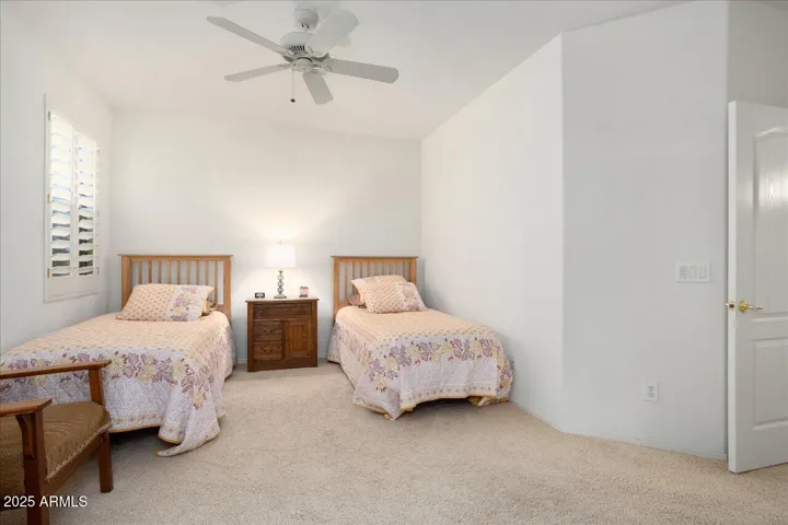 This primary bedroom #2 has a double door entry. It is a spacious room and currently has double beds for guests.
