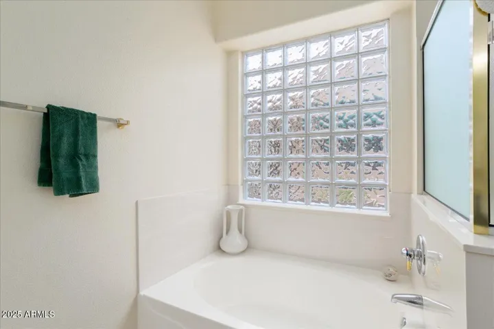 This bath has a nice block window for light, but offers privacy for the shower and garden tub! Your own oasis after a (hopefully!) enjoyable day at golf or pickleball!