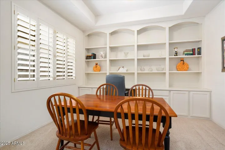 The formal dining room has a wall of built-in cabinets and shelving. With this nice storage, the room could also be a nice home office!