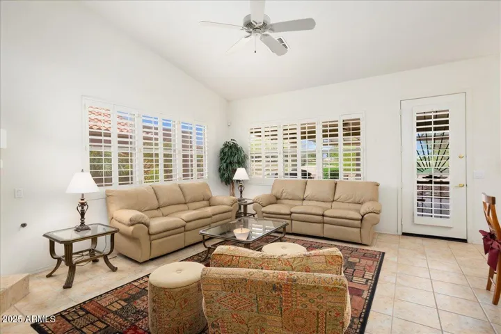 This is the family room or Arizona great room! It has expansive views of the golf course and is open to the kitchen and breakfast room!