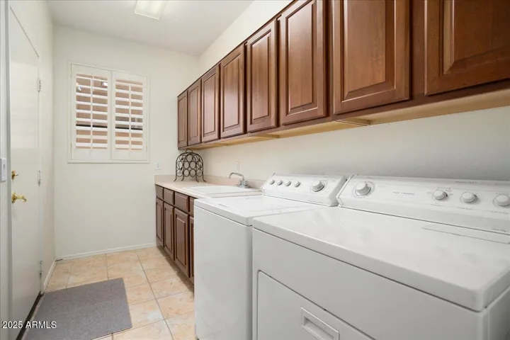 This is a really nice laundry room with lots of cabinets, and which also has a deep sink! Washer and dryer will convey!