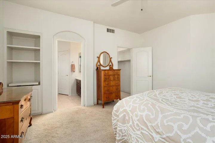 This room has a good sized walk=in closet, and additional shelves & cabinet to the left. The doorway leads to the ensuite bath.