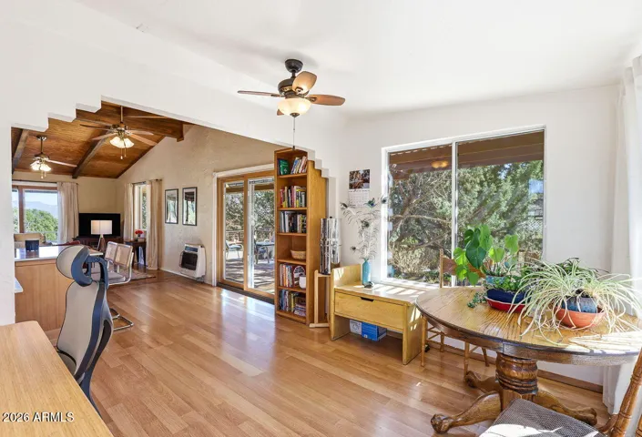 Open dining area flowing into living space with deck access and natural light. Comfortable indoor-outdoor living in Hackberry AZ.