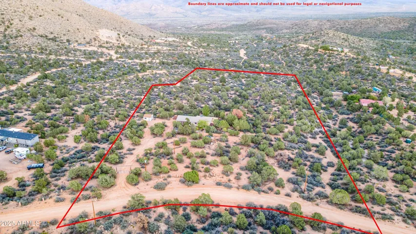 Aerial perspective highlights the approximate lot boundaries, showcasing the home’s impressive footprint across open desert terrain. Ideal for buyers seeking acreage, privacy, and the freedom to develop or enjoy wide natural landscapes in Hackberry.