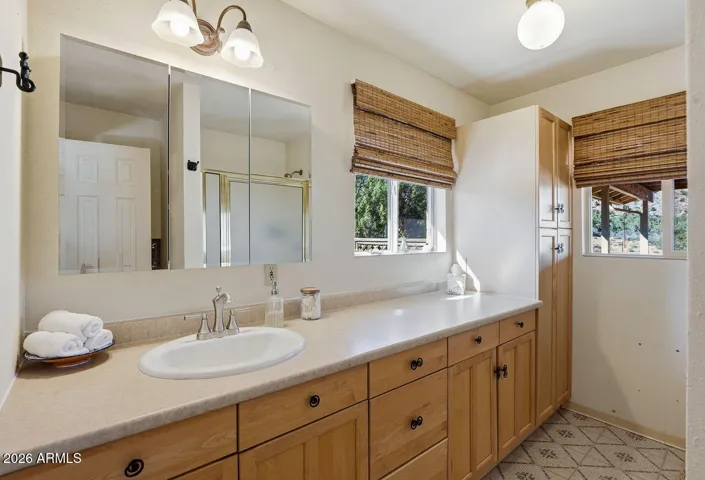Bathroom with long vanity, storage cabinets and natural light. Functional layout in Hackberry AZ home near Kingman.