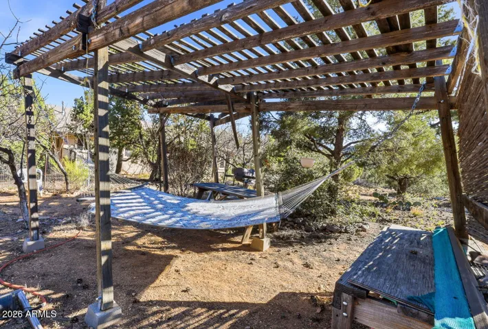 Outdoor pergola with hammock and shaded seating area. Relax under desert skies in Hackberry AZ near Route 66.