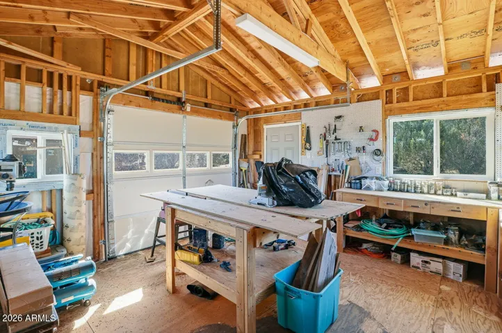 Detached workshop garage with workbench and storage. Ideal for hobbyists, mechanics, or tools at this Hackberry Arizona property.