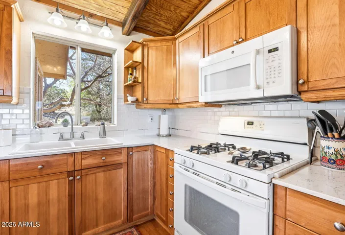 Bright kitchen with window above sink and natural light. Functional layout in this Hackberry AZ home near Kingman.
