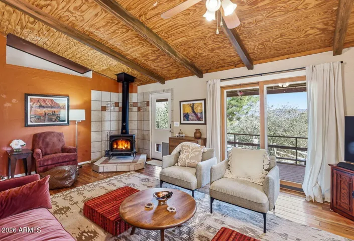 Relaxing living area with wood stove and deck views. Charming desert retreat home in Hackberry Arizona.