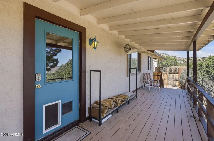 Welcoming front porch entry with mountain views and wood storage. Peaceful rural setting in Hackberry Arizona.