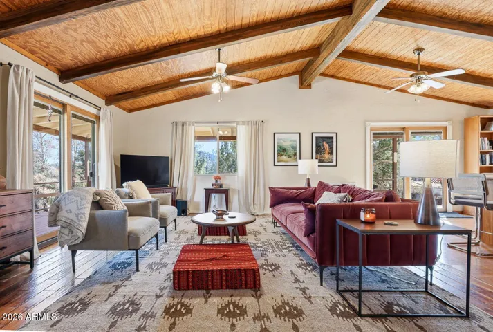 Living room with sliding doors opening to scenic deck views. Enjoy indoor-outdoor living in Hackberry AZ near Kingman.