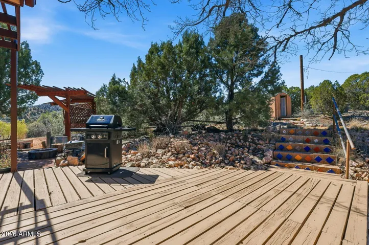 Spacious deck with grilling area and pergola seating. Ideal for entertaining under Arizona’s high desert skies.