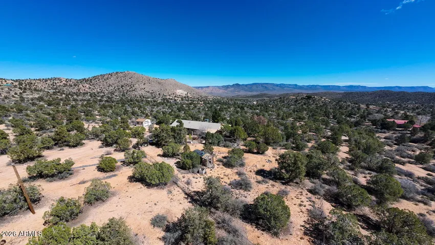 Experience the golden light across the Hackberry valley floor. A stunning perspective of the expansive acreage and diverse Arizona terrain.