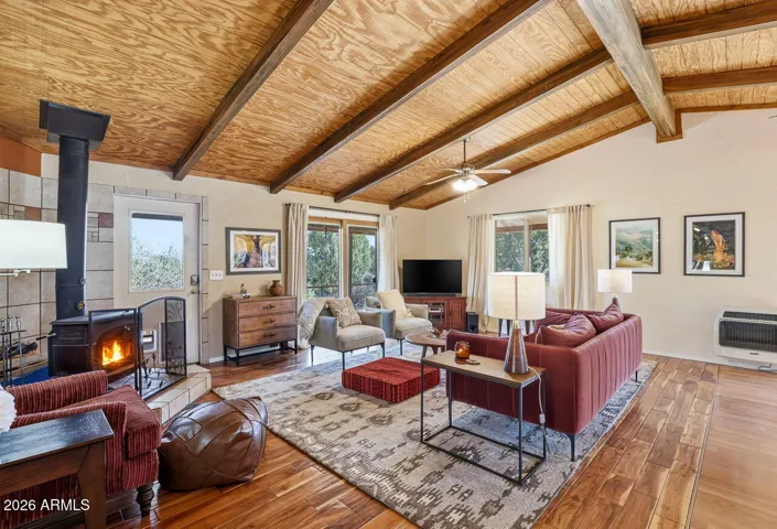 Cozy living room with wood stove and vaulted wood ceiling. Comfortable desert home living in Hackberry AZ near Route 66 and Kingman.