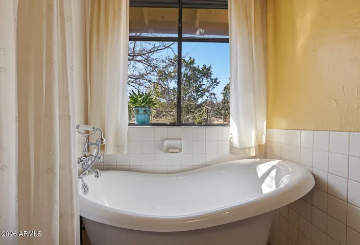 Classic clawfoot tub with natural light and scenic views. Peaceful desert spa feel in Hackberry Arizona.