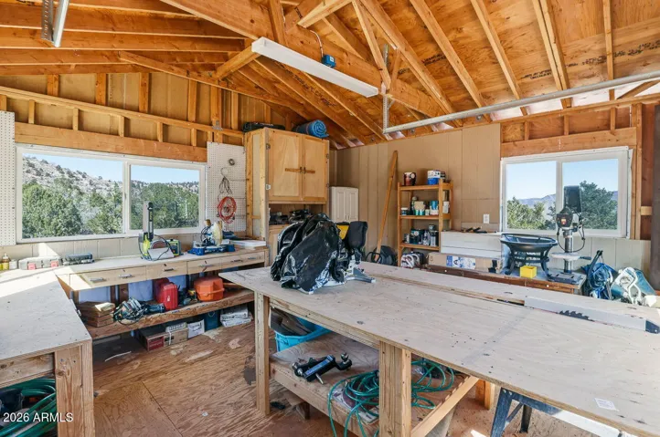 Spacious workshop with work tables and natural light. Perfect workspace for projects at this rural Hackberry AZ home near Kingman.