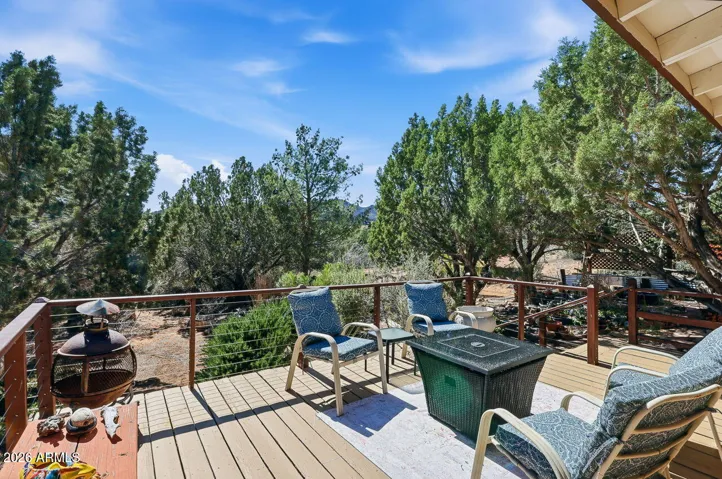 Elevated deck at this Hackberry AZ home near Kingman. Enjoy peaceful mountain views and outdoor living surrounded by mature desert trees.