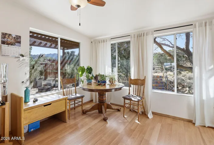 Bright dining nook with large windows and garden views. Enjoy natural light and peaceful desert scenery in Hackberry Arizona.