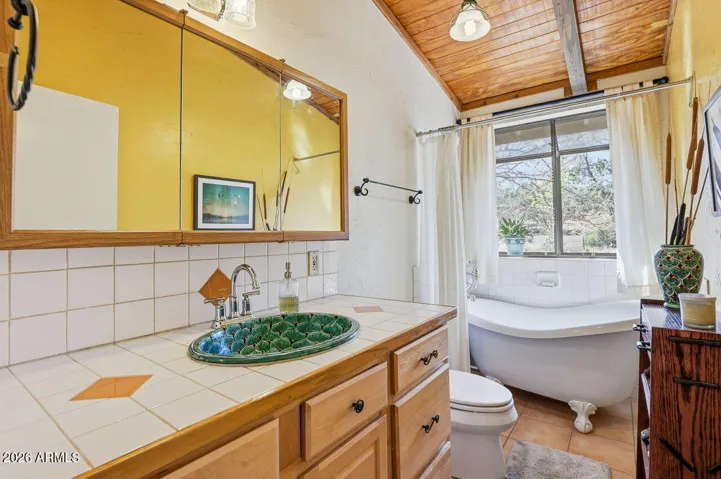 Charming bathroom with clawfoot soaking tub and garden views. Relaxing retreat in Hackberry AZ.