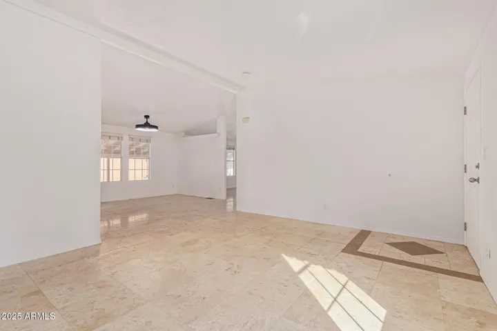 Custom stone mosaic frames the entrance. Great room with vaulted ceilings!
