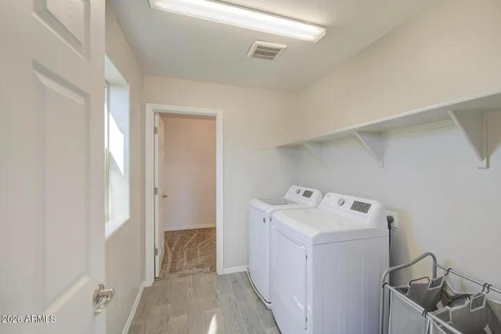 Nice size laundry with plenty of storage space.