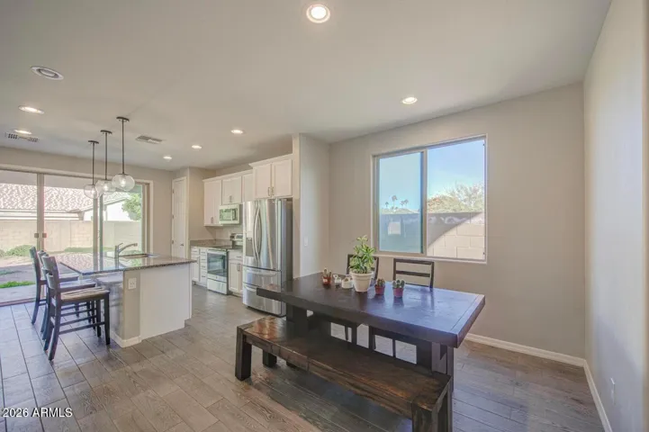 Brightly lit main dining area that flows nicely into the overall feel of the home's primary entertaining space and helps to create a welcoming atmosphere.