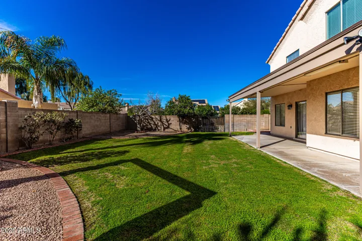 The backyard boasts different spaces for entertainment, zen, sports, leisure, and space to add a pool!