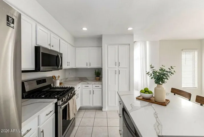 Bright, clean, and effortlessly functional—this kitchen offers timeless finishes, stainless steel appliances, and an easy flow into the dining space, perfect for everyday living and hosting. Virtually Staged