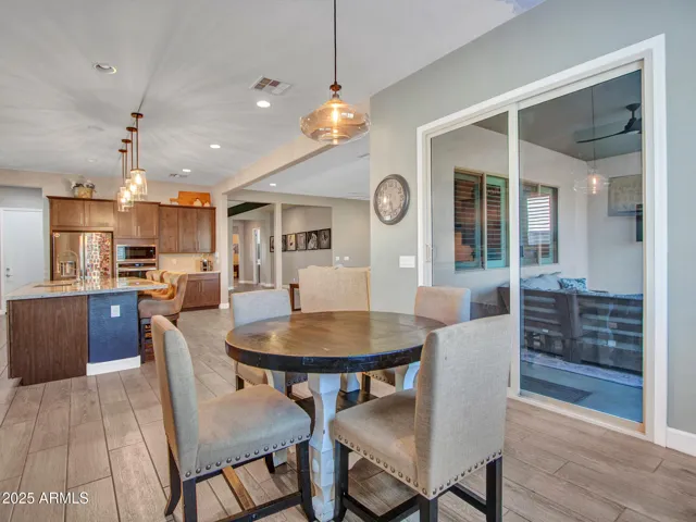 Breakfast nook with pendant lighting and patio exit