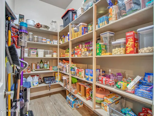 One of two oversized walk-in pantries providing incredible storage and organization for a clutter-free kitchen
