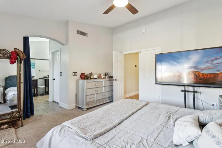 Primary with double door entry, and view of primary bath