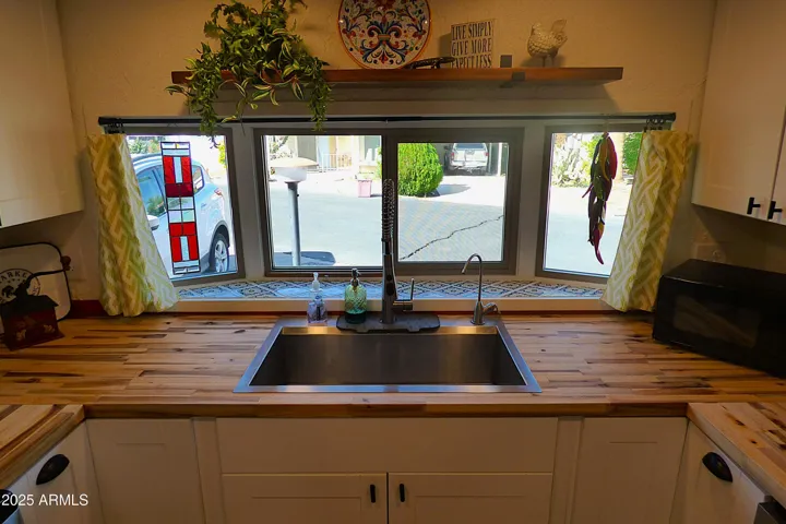 Kitchen sink overlooks front entry and has lots of room for growing plants and herbs!