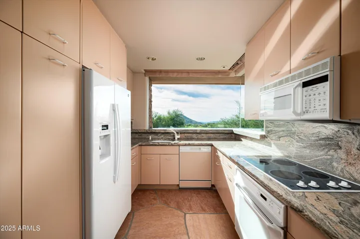 Full kitchen with cooktop, microwave, refrigerator