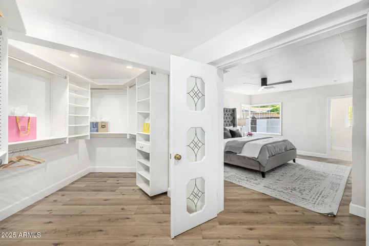 The primary closet is unusually oversized with a Classy Closets buildout.